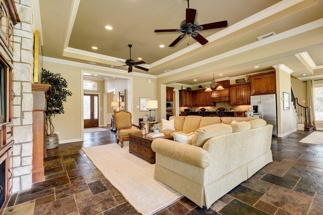 51 Northwood Ct, Lake Jackson, TX 77566 - living area with a fireplace, a raised ceiling, ornamental molding, a ceiling fan, and stone tile flooring