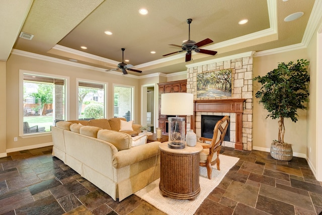 51 Northwood Ct, Lake Jackson, TX 77566 - living room with a raised ceiling, a ceiling fan, a fireplace, ornamental molding, and baseboards