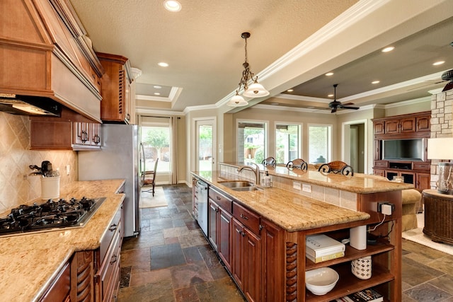 51 Northwood Ct, Lake Jackson, TX 77566 - kitchen with appliances with stainless steel finishes, a sink, stone tile flooring, a spacious island, and ornamental molding