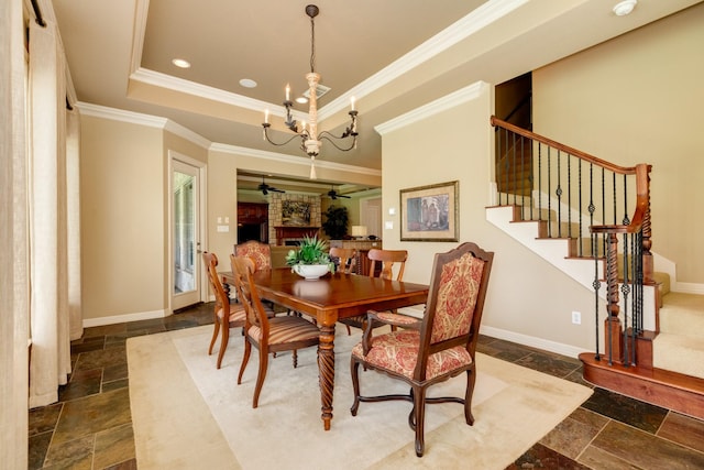 51 Northwood Ct, Lake Jackson, TX 77566 - dining space with stone tile floors, a chandelier, a ceiling fan, stairway, and ornamental molding