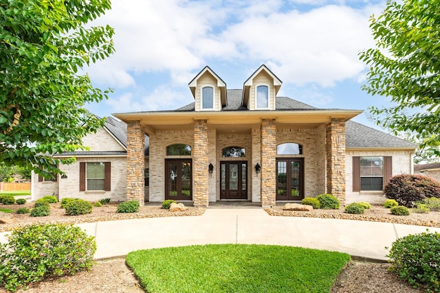51 Northwood Ct, Lake Jackson, TX 77566 - view of front of home with french doors, a shingled roof, and brick siding