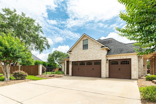51 Northwood Ct, Lake Jackson, TX 77566 - view of front of home featuring concrete driveway, brick siding, an attached garage, and a shingled roof