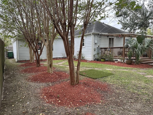 2044 Des Jardines St, Houston, TX 77023 - view of side of home with a shingled roof and a deck