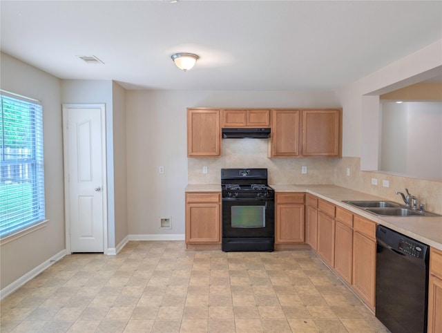 7027 Parkford Meadow Dr, Cypress, TX 77433 - kitchen with black appliances, a sink, under cabinet range hood, light countertops, and decorative backsplash