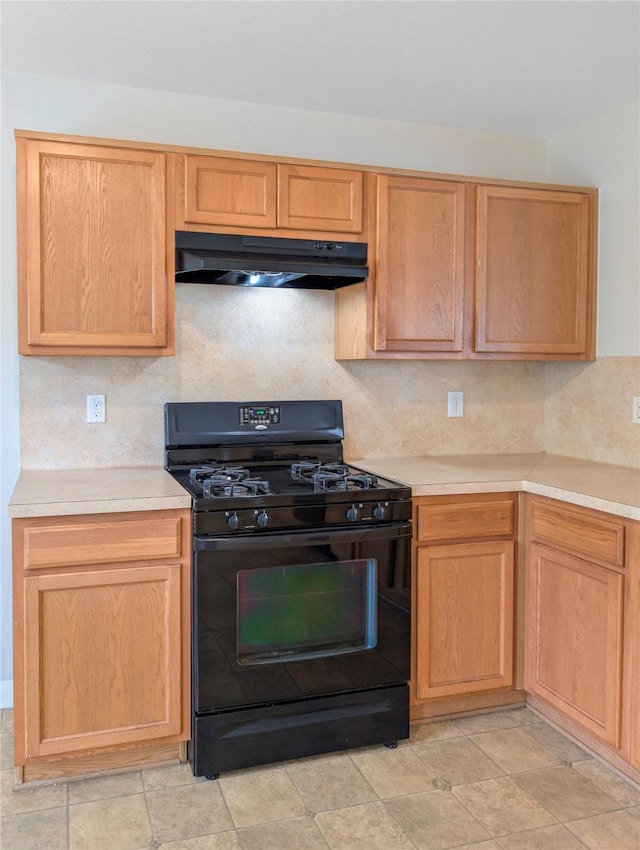 7027 Parkford Meadow Dr, Cypress, TX 77433 - kitchen with black range with gas cooktop, under cabinet range hood, light countertops, and backsplash