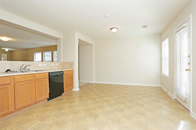 7027 Parkford Meadow Dr, Cypress, TX 77433 - kitchen with black dishwasher, backsplash, a sink, light countertops, and baseboards
