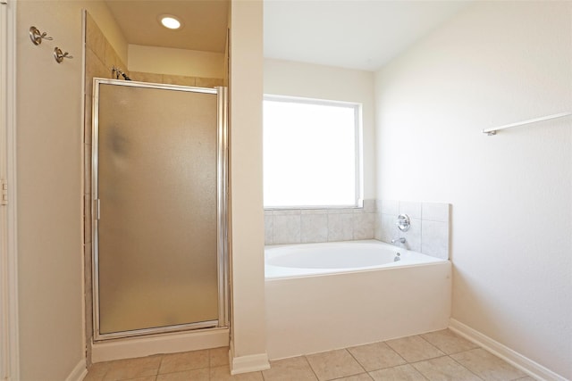 7027 Parkford Meadow Dr, Cypress, TX 77433 - bathroom with tile patterned floors, a stall shower, a garden tub, and baseboards