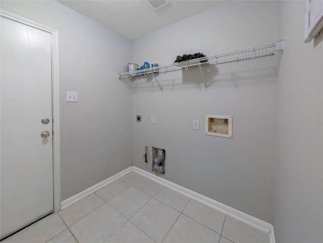7027 Parkford Meadow Dr, Cypress, TX 77433 - laundry room featuring hookup for an electric dryer, hookup for a washing machine, light tile patterned floors, hookup for a gas dryer, and baseboards