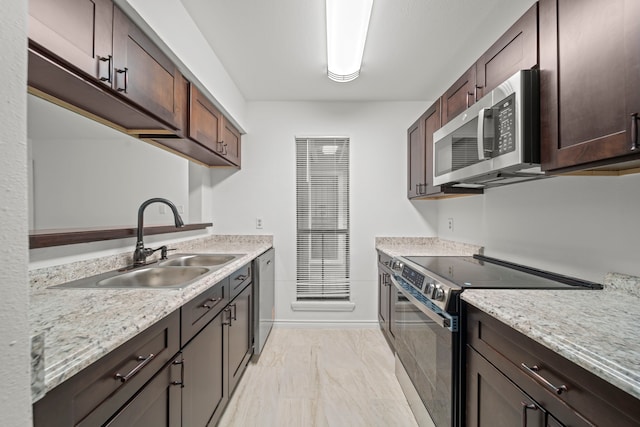 3500 Tangle Brush Dr Unit 48, The Woodlands, TX 77381 - kitchen featuring appliances with stainless steel finishes, a sink, a heating unit, dark brown cabinets, and baseboards