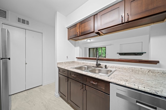 3500 Tangle Brush Dr Unit 48, The Woodlands, TX 77381 - kitchen featuring stainless steel appliances, a sink, and light marble finish flooring