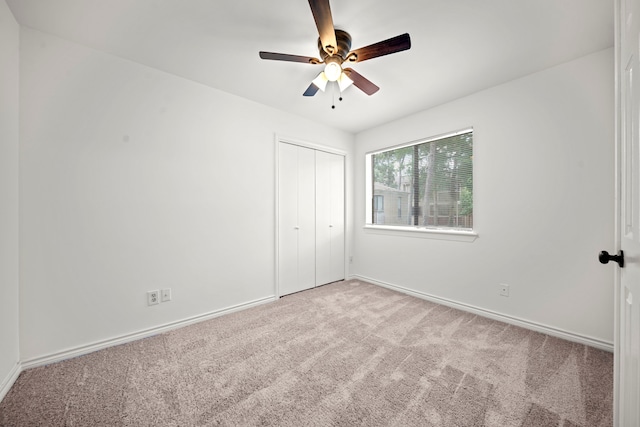 3500 Tangle Brush Dr Unit 48, The Woodlands, TX 77381 - unfurnished bedroom featuring carpet, baseboards, a closet, and ceiling fan