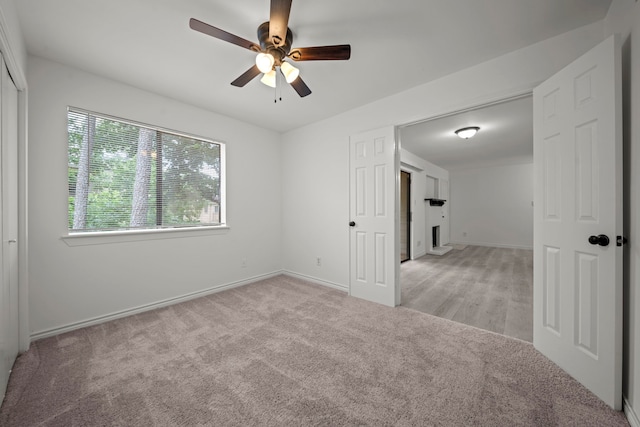 3500 Tangle Brush Dr Unit 48, The Woodlands, TX 77381 - empty room featuring light colored carpet, ceiling fan, and baseboards