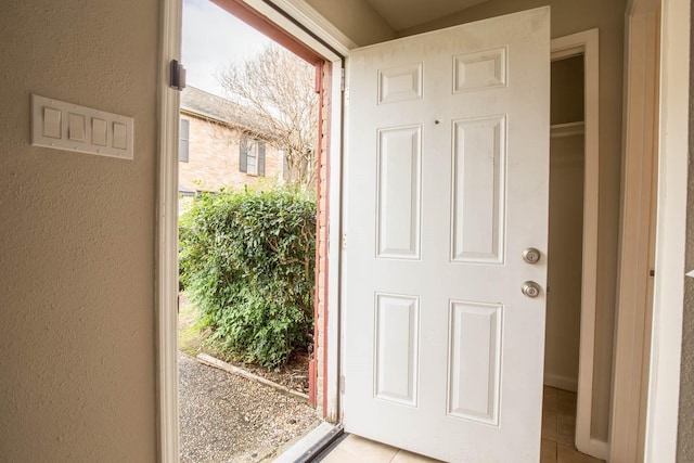 4064 Belle Park Dr Unit 4064, Houston, TX 77072 - doorway to outside featuring light tile patterned flooring and a textured wall