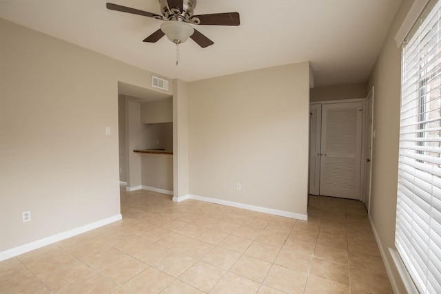 4064 Belle Park Dr Unit 4064, Houston, TX 77072 - spare room with light tile patterned floors, a ceiling fan, and baseboards