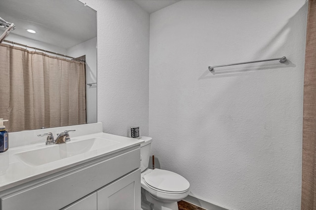 1709 Perch St, Alvin, TX 77511 - full bathroom with a textured wall, toilet, vanity, and a shower with shower curtain