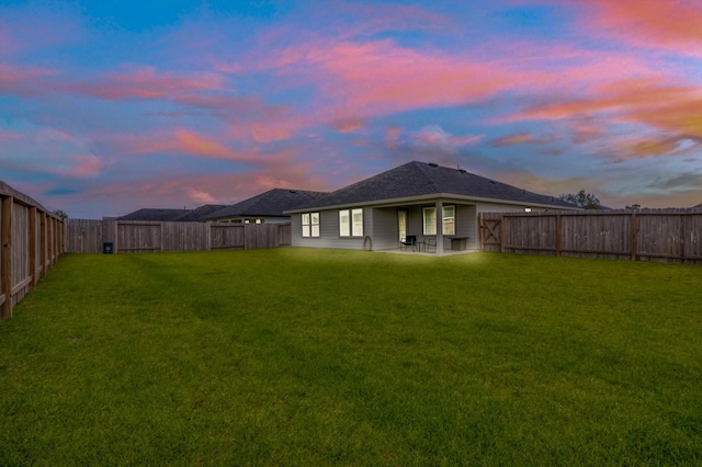 1709 Perch St, Alvin, TX 77511 - back of house at dusk with a patio
