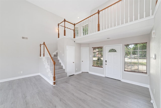 14651 Via Del Norte Dr, Houston, TX 77083 - entryway with stairs, a high ceiling, healthy amount of natural light, baseboards, and wood finished floors