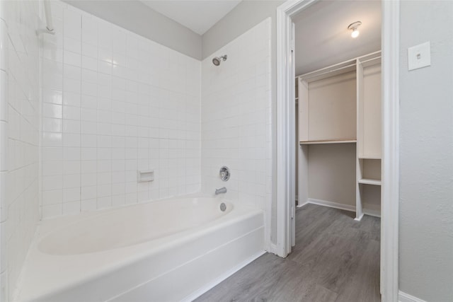 14651 Via Del Norte Dr, Houston, TX 77083 - bathroom featuring wood finished floors,  shower combination, a spacious closet, and baseboards