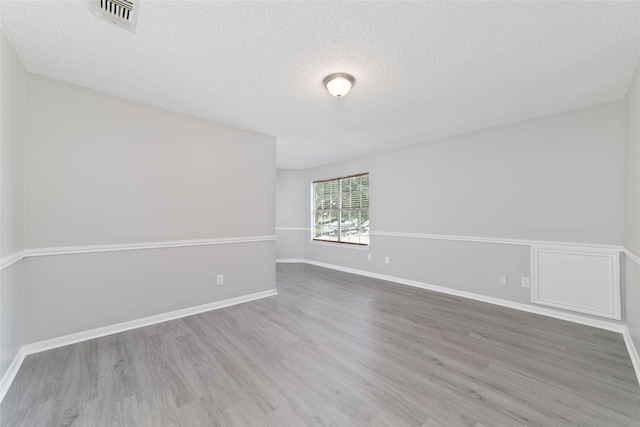 14651 Via Del Norte Dr, Houston, TX 77083 - spare room featuring wood finished floors, a textured ceiling, and baseboards