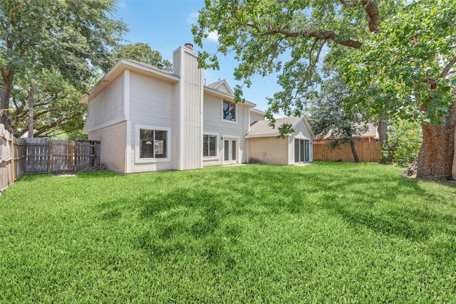 14651 Via Del Norte Dr, Houston, TX 77083 - rear view of property featuring a chimney and brick siding