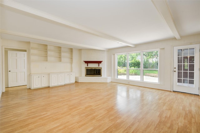 10902 Brentway Dr, Houston, TX 77070 - unfurnished living room featuring beamed ceiling, light wood finished floors, and a fireplace