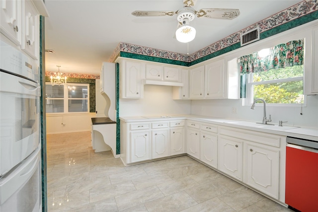 10902 Brentway Dr, Houston, TX 77070 - kitchen with dishwashing machine, white cabinetry, light countertops, ceiling fan, and a chandelier