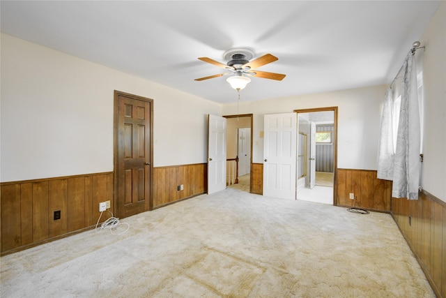 10902 Brentway Dr, Houston, TX 77070 - unfurnished bedroom with wood walls, a wainscoted wall, carpet flooring, and ceiling fan