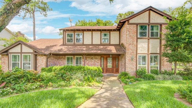 10902 Brentway Dr, Houston, TX 77070 - tudor home with stucco siding, roof with shingles, and brick siding