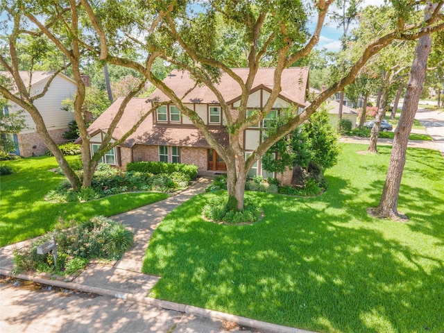 10902 Brentway Dr, Houston, TX 77070 - tudor home with a front lawn and brick siding