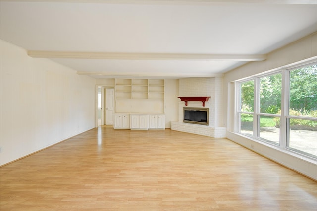 10902 Brentway Dr, Houston, TX 77070 - unfurnished living room featuring beamed ceiling, light wood finished floors, a fireplace, and built in shelves