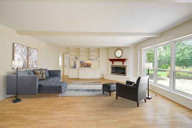 10902 Brentway Dr, Houston, TX 77070 - living room with light wood finished floors, healthy amount of natural light, beamed ceiling, and a fireplace