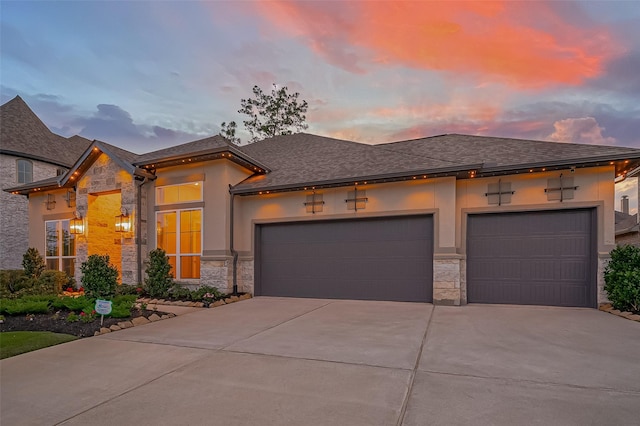 17414 Orchid Falls Ln, Conroe, TX 77302 - view of front of house featuring stone siding, driveway, a garage, and stucco siding