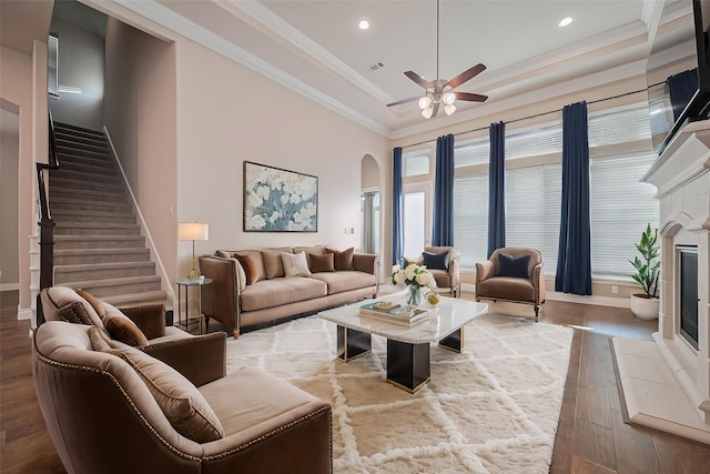 17414 Orchid Falls Ln, Conroe, TX 77302 - living area featuring wood finished floors, arched walkways, ceiling fan, stairs, and recessed lighting