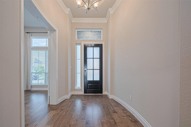 17414 Orchid Falls Ln, Conroe, TX 77302 - foyer featuring a chandelier, ornamental molding, dark wood-style floors, and baseboards