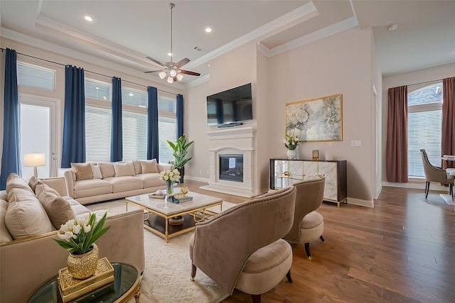 17414 Orchid Falls Ln, Conroe, TX 77302 - living room featuring a high end fireplace, wood finished floors, baseboards, ornamental molding, and ceiling fan