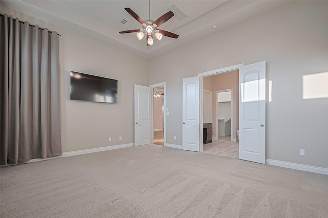 17414 Orchid Falls Ln, Conroe, TX 77302 - unfurnished bedroom with light carpet, baseboards, a high ceiling, and ceiling fan