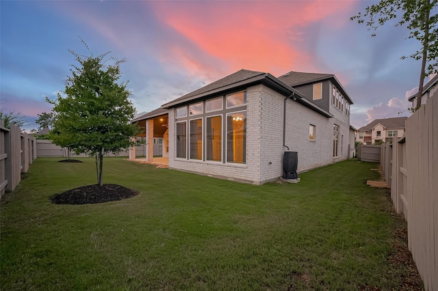 17414 Orchid Falls Ln, Conroe, TX 77302 - back of house at dusk with brick siding
