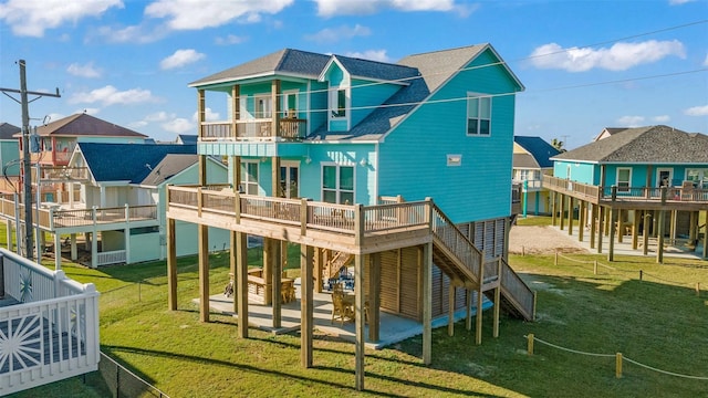 2336 Martinique, Crystal Beach, TX 77650 - back of house with a balcony, a shingled roof, a patio area, stairway, and a residential view