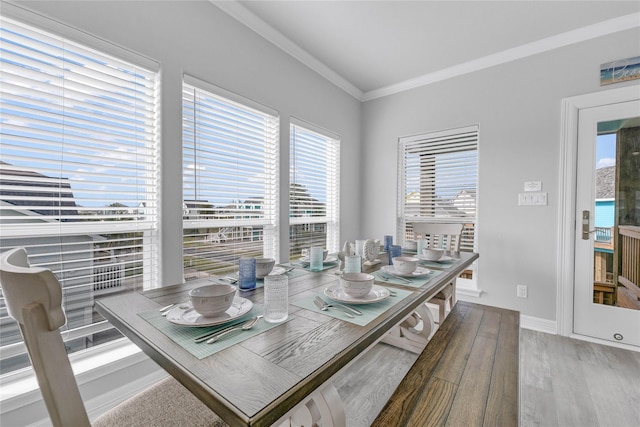 2336 Martinique, Crystal Beach, TX 77650 - dining space with light wood-style flooring, ornamental molding, and baseboards