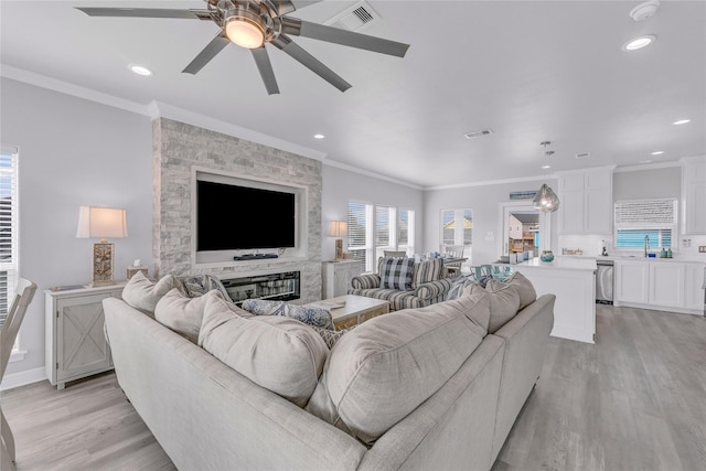 2336 Martinique, Crystal Beach, TX 77650 - living room with light wood finished floors, a ceiling fan, ornamental molding, recessed lighting, and baseboards