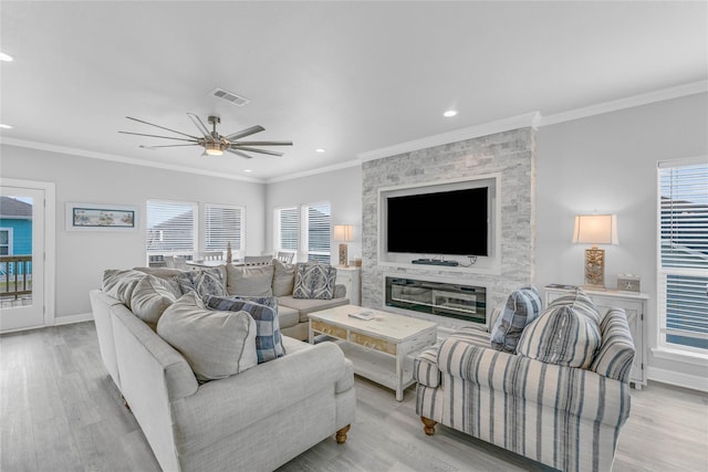 2336 Martinique, Crystal Beach, TX 77650 - living area with ceiling fan, light wood-style floors, crown molding, plenty of natural light, and baseboards