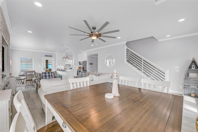 2336 Martinique, Crystal Beach, TX 77650 - dining area featuring a ceiling fan, crown molding, stairs, recessed lighting, and light wood finished floors