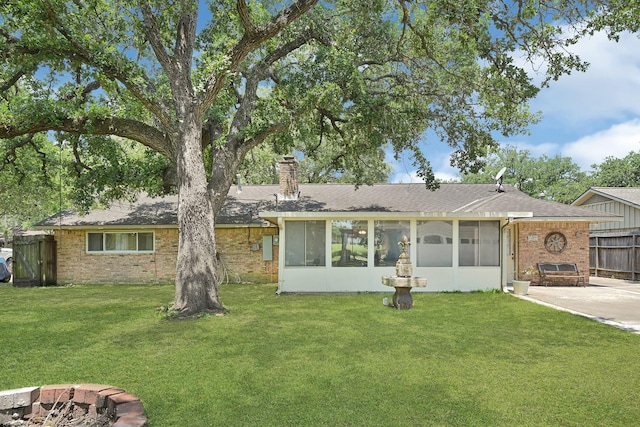 2022 Willow Wisp Dr, Seabrook, TX 77586 - rear view of property with brick siding, a chimney, a shingled roof, a sunroom, and a patio area