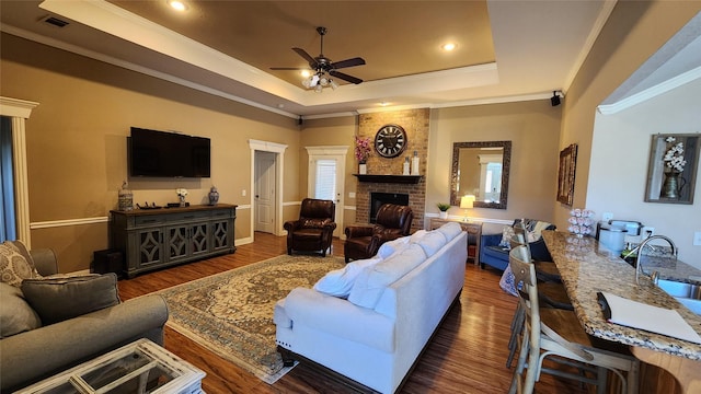3905 Sierra Pl, Amarillo, TX 79118 - living room with a raised ceiling, ornamental molding, ceiling fan, wood finished floors, and a fireplace