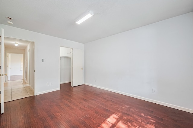 10111 Woodico Ct, Houston, TX 77038 - unfurnished bedroom with wood finished floors, baseboards, and a closet