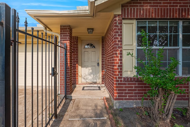 10111 Woodico Ct, Houston, TX 77038 - doorway to property with brick siding and a gate