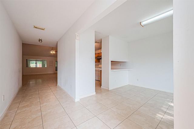 10111 Woodico Ct, Houston, TX 77038 - empty room featuring light tile patterned flooring, a ceiling fan, and baseboards