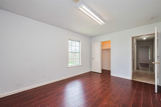 10111 Woodico Ct, Houston, TX 77038 - unfurnished bedroom with wood finished floors, baseboards, a spacious closet, and a closet