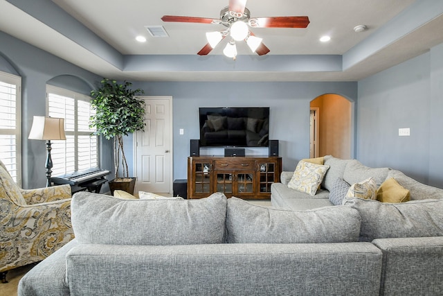 8423 Glenn Leigh Dr NE, Spring, TX 77379 - living room featuring arched walkways, a ceiling fan, a tray ceiling, and recessed lighting
