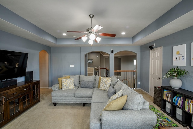 8423 Glenn Leigh Dr NE, Spring, TX 77379 - living area featuring arched walkways, a tray ceiling, a ceiling fan, light carpet, and recessed lighting